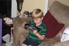 Alexander figuring out the <b>Speed Racer</b> steering wheel...