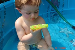 Alexander checks out a water gun...