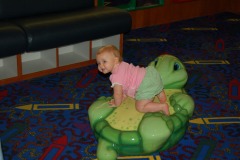 Kathryn tries out the turtle in the play area at Crabtree Valley Mall...