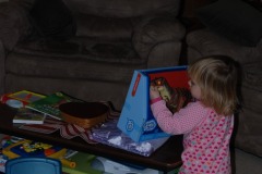 Katie playing with the dinosaur...