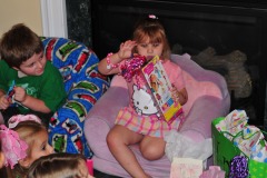 Katie ascends the princess throne for presents with her trusty helper...