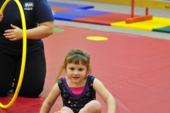 Katie does a forward roll through the hoop...