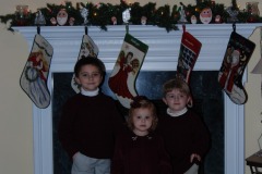 All three kids in front of the fireplace...
