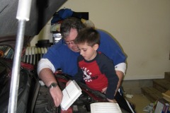 Nicholas and Daddy replacing the air filter...