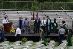 The graduates are beginning to file into the rows of seats...